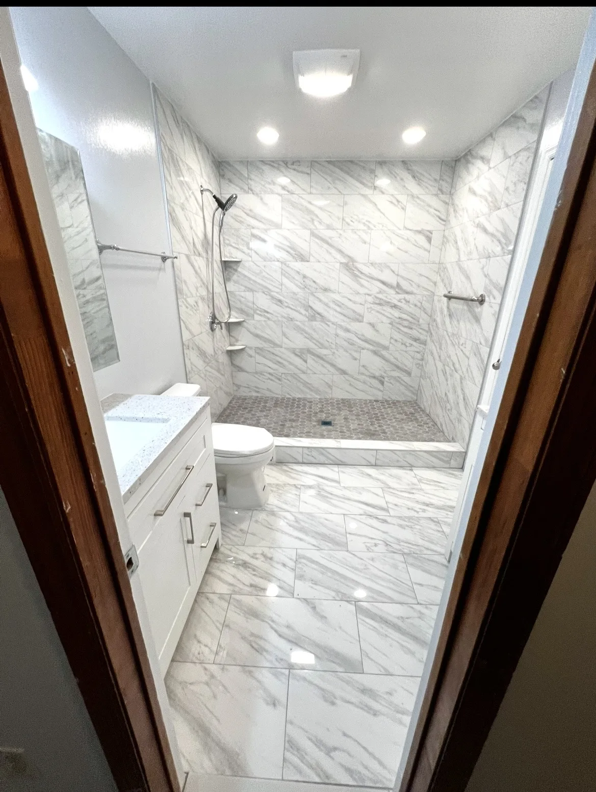 Bathroom remodeling project with updated vanity lighting and finishes