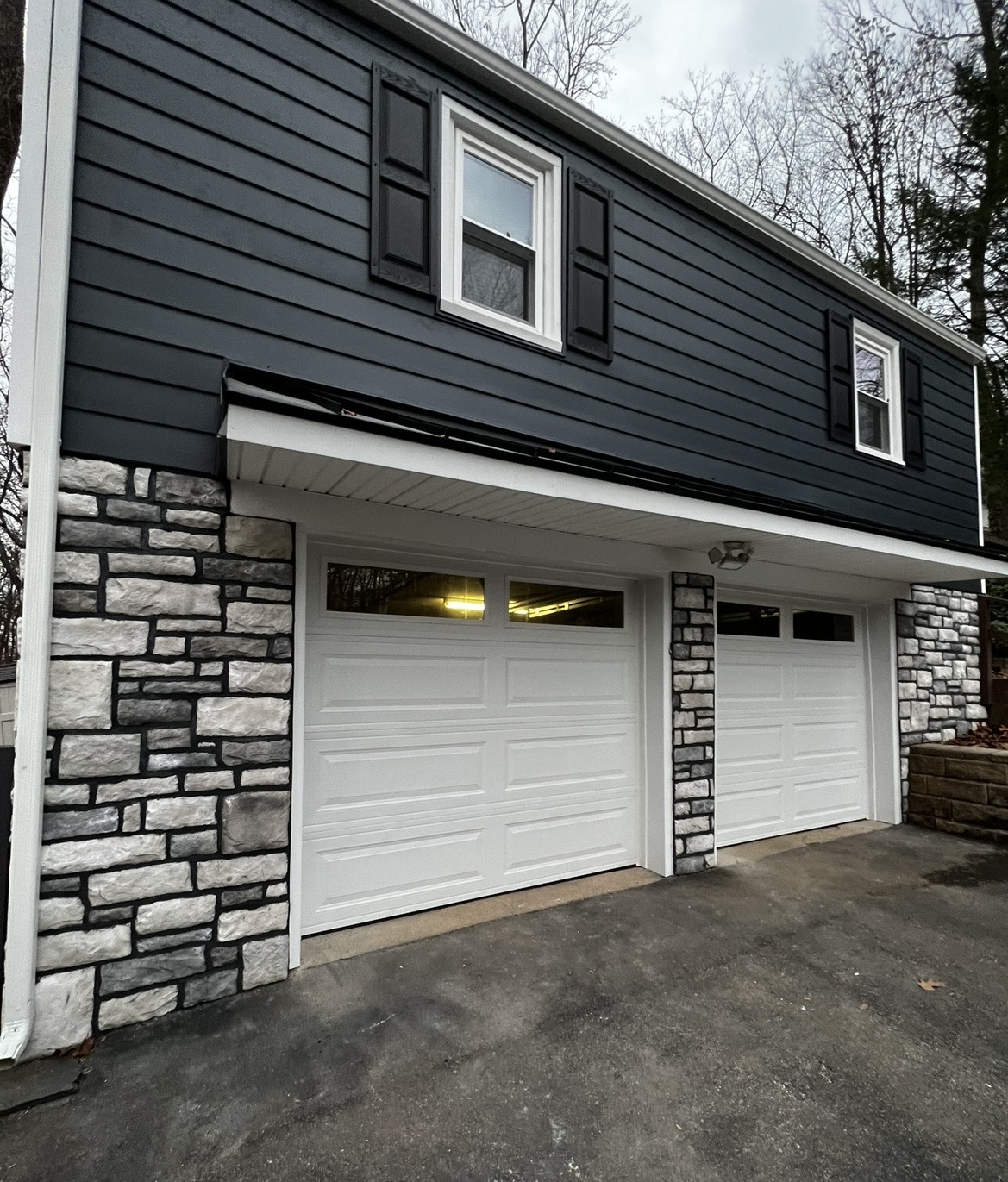Close-up of stone veneer garage masonry completed by KesRemodel